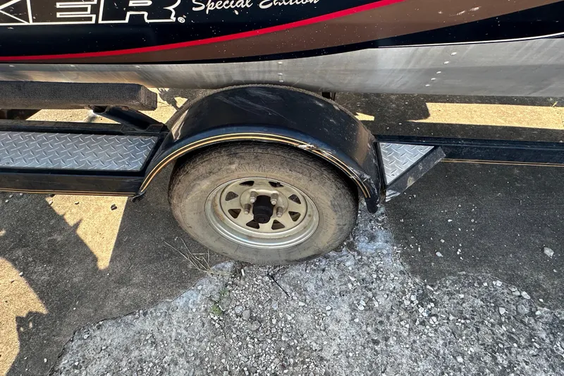 Slide: The Image of 1999 Tracker Pro Team 185 trailer wheel and fender on concrete surface. - 21