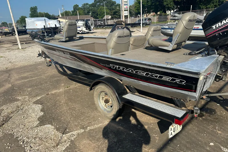 Slide: The Image of 1999 Tracker Pro Team 185 boat on trailer, parked outdoors in a lot. - 6