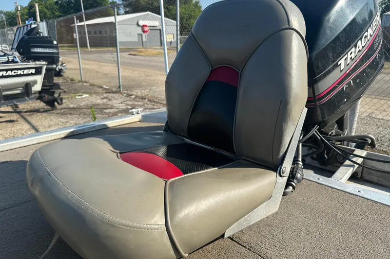 Slide: The Image of 1999 Tracker Pro Team 185 boat seat with motor in background. - 12