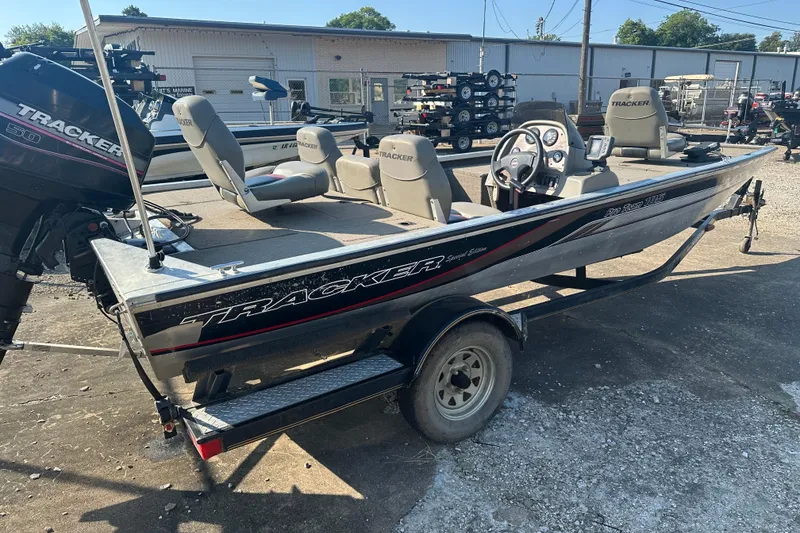 Slide: The Image of 1999 Tracker Pro Team 185 boat with trailer, parked outdoors. - 5