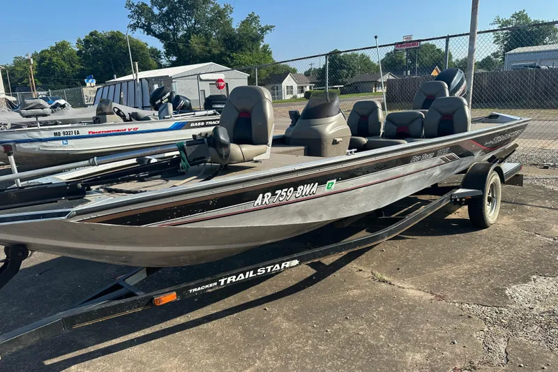 Slide: The Image of 1999 Tracker Pro Team 185 boat on trailer, parked outdoors in a lot. - 3
