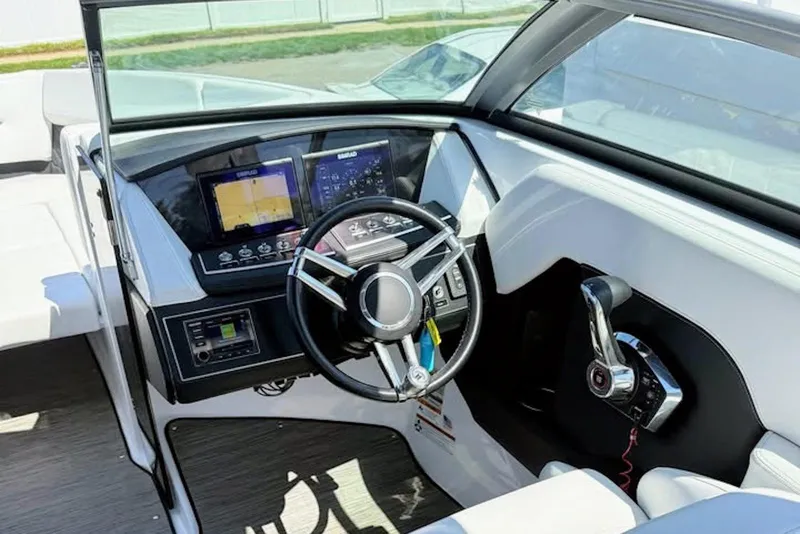 Slide: The Image of Cockpit of 2022 Four Winns H4 OB boat with modern steering and control panel. - 6