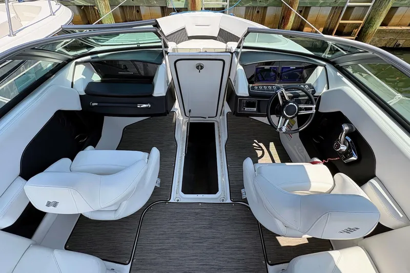 Slide: The Image of Interior view of 2022 Four Winns H4 OB boat with modern seating and dashboard. - 5