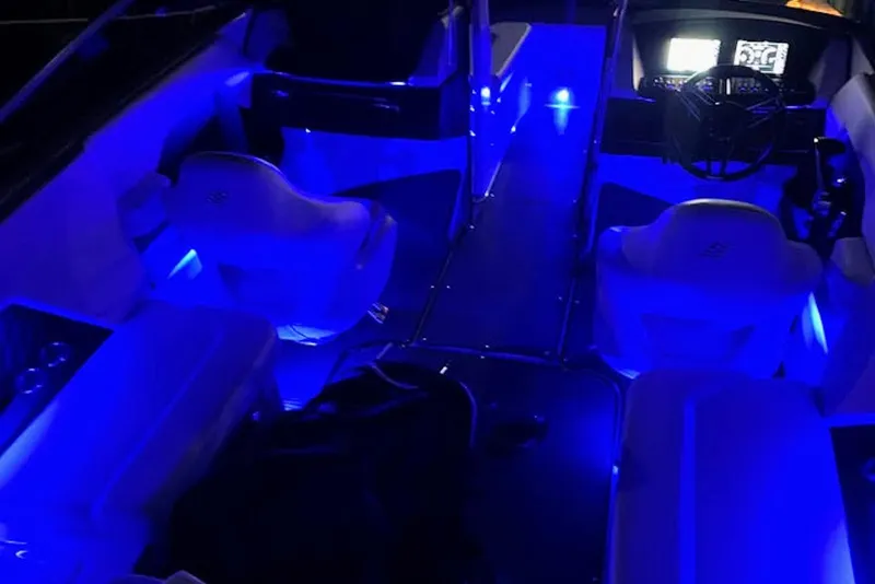 Slide: The Image of 2022 Four Winns H4 OB boat interior with blue LED lighting. - 15