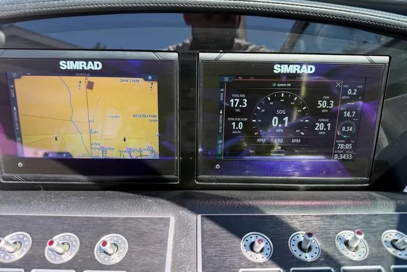 Slide: The Image of Simrad navigation and control screens on a 2022 Four Winns H4 OB boat dashboard. - 8