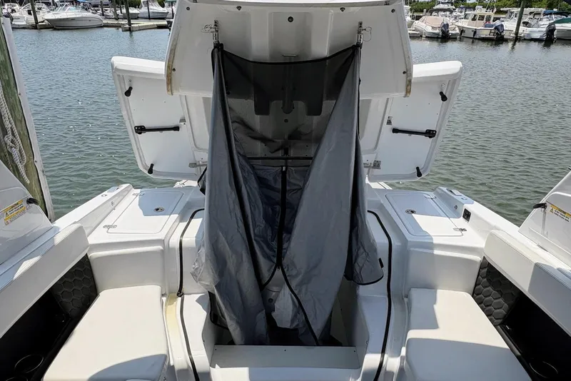 Slide: The Image of 2022 Four Winns H4 OB boat with open storage compartments at marina. - 17