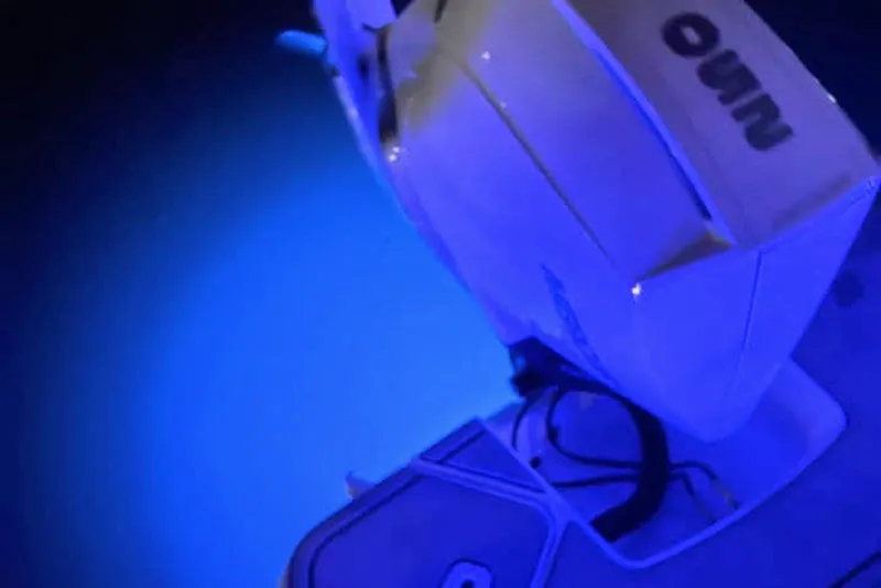 Slide: The Image of 2022 Four Winns H4 OB boat engine illuminated by blue underwater lights. - 16