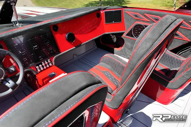 Slide: The Image of Luxurious interior of 2024 Skater 368 boat with red and black accents, advanced dashboard. - 17