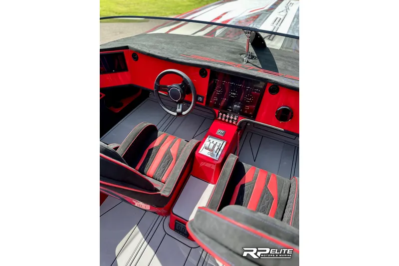 Slide: The Image of Interior of 2024 Skater 368 boat with sleek red and black design, modern controls. - 13