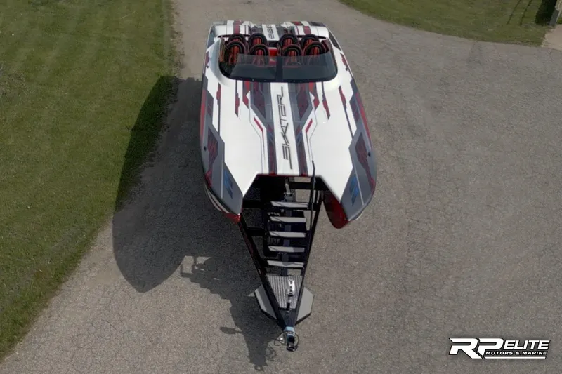Slide: The Image of 2024 Skater 368 powerboat on trailer, aerial view, sleek design, white with red accents. - 45