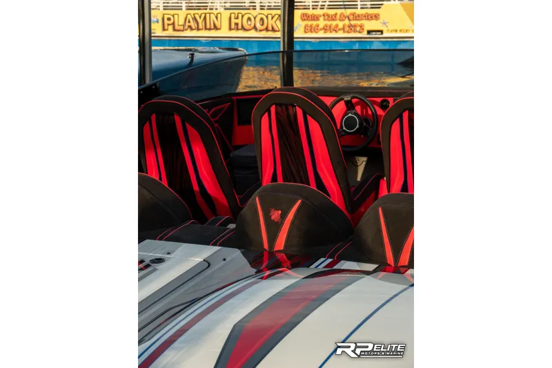 Slide: The Image of Interior of 2024 Skater 368 boat with red and black seats, steering wheel visible. - 27