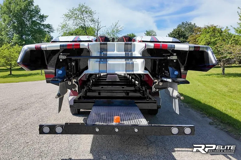 Slide: The Image of 2024 Skater 368 boat on trailer, rear view, showcasing sleek design and powerful engines. - 35