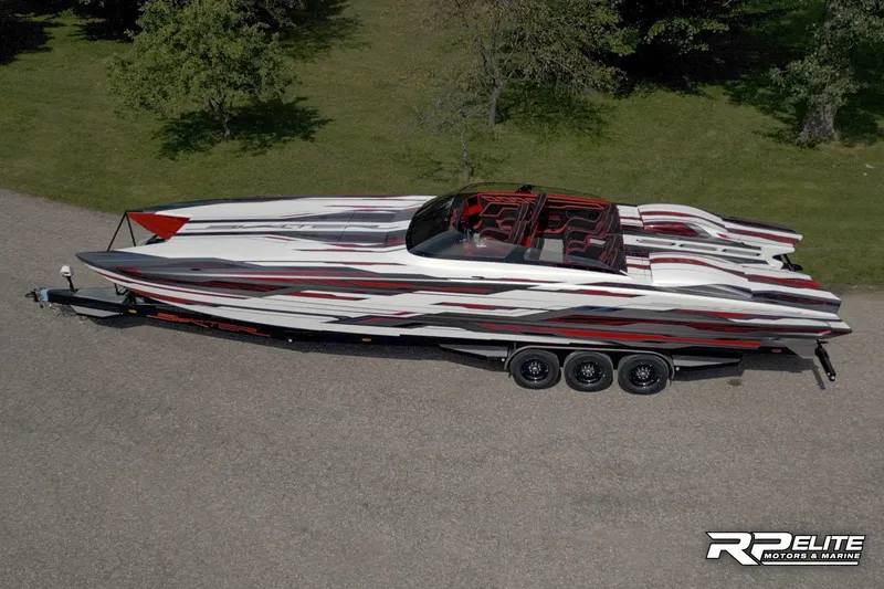 Slide: The Image of 2024 Skater 368 powerboat with sleek design on a triple-axle trailer, parked outdoors. - 43