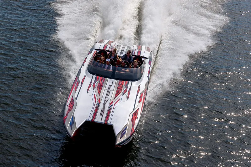 Slide: The Image of 2024 Skater 368 speedboat racing on water, showcasing sleek design and vibrant graphics. - 4