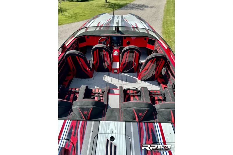 Slide: The Image of 2024 Skater 368 boat interior with red and black seating, sleek design, and modern dashboard. - 8