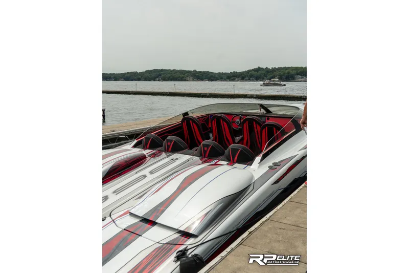 Slide: The Image of 2024 Skater 368 powerboat with sleek design docked by a scenic lake. - 30