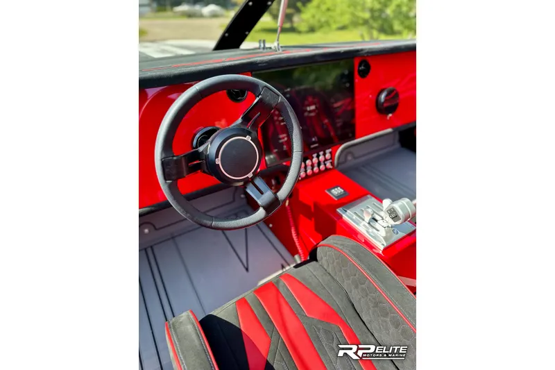 Slide: The Image of Red and black interior of 2024 Skater 368 boat with modern steering wheel. - 16