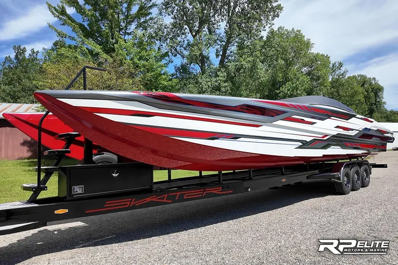 Slide: The Image of 2024 Skater 368 powerboat on trailer, featuring sleek red and white design, parked outdoors. - 34