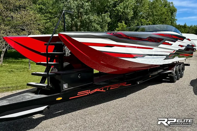 Slide: The Image of 2024 Skater 368 powerboat with sleek red and white design on a trailer. - 50