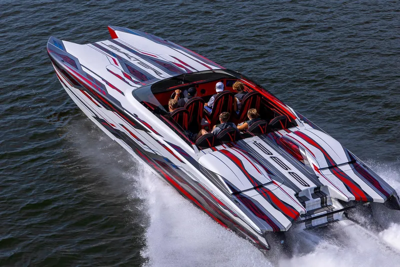 Slide: The Image of 2024 Skater 368 speedboat with vibrant red and white design cruising on water. - 1