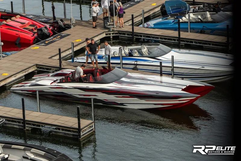 Slide: The Image of 2024 Skater 368 speedboat docked at marina with vibrant design and people onboard. - 7