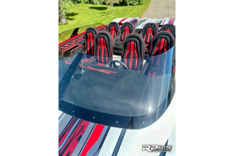 Slide: The Image of 2024 Skater 368 boat with sleek design, red and black seats, and aerodynamic windshield. - 9