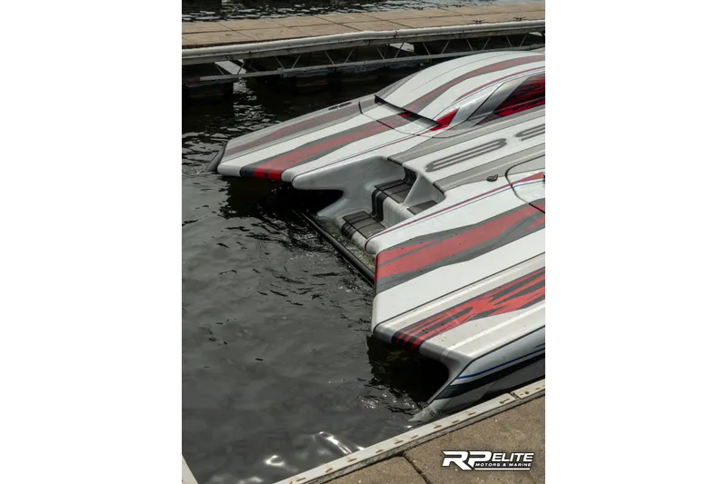 Slide: The Image of 2024 Skater 368 powerboat with sleek design and red accents docked at marina. - 29