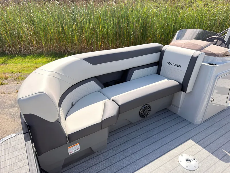 Slide: The Image of The image shows a modern seating area on a 2027 Sylvan Q-22 ULZ boat. - 11
