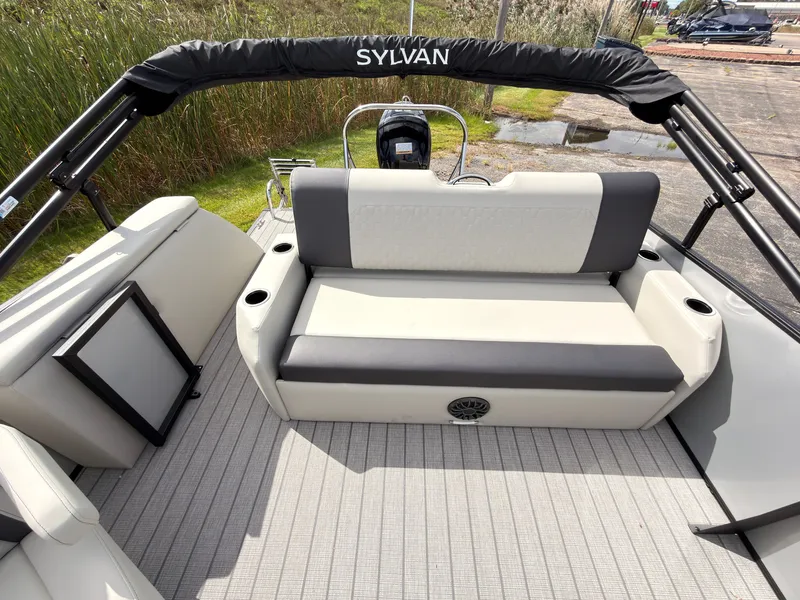 Slide: The Image of The image shows the rear of a 2027 Sylvan Q-22 ULZ boat with gray upholstery. - 41