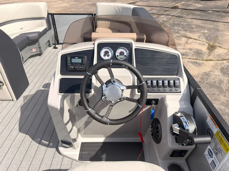 Slide: The Image of The image shows the helm of a 2027 Sylvan Q-22 ULZ with modern instruments and controls. - 31