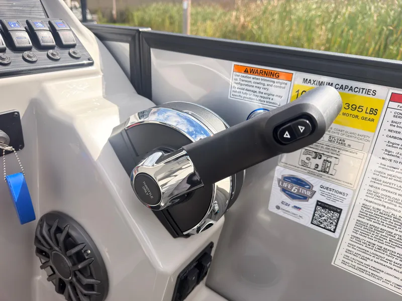Slide: The Image of Close-up of the throttle lever on a Sylvan Q-22 ULZ boat with warning labels and capacity details. - 37