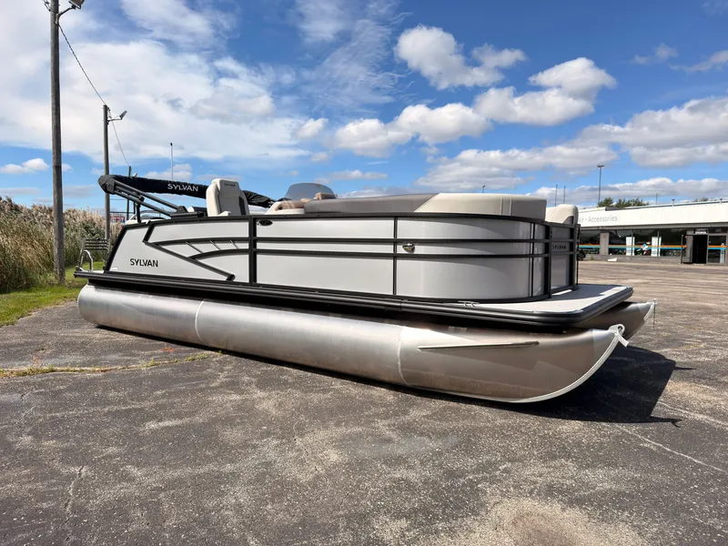 Slide: The Image of A 2027 Sylvan Q-22 ULZ pontoon boat is parked on a lot. It features a modern design. - 8
