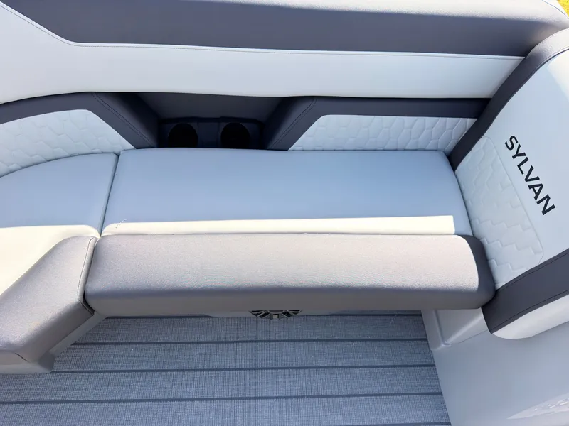 Slide: The Image of The image shows a modern, cushioned bench seat in a Sylvan Q-22 ULZ boat. - 14