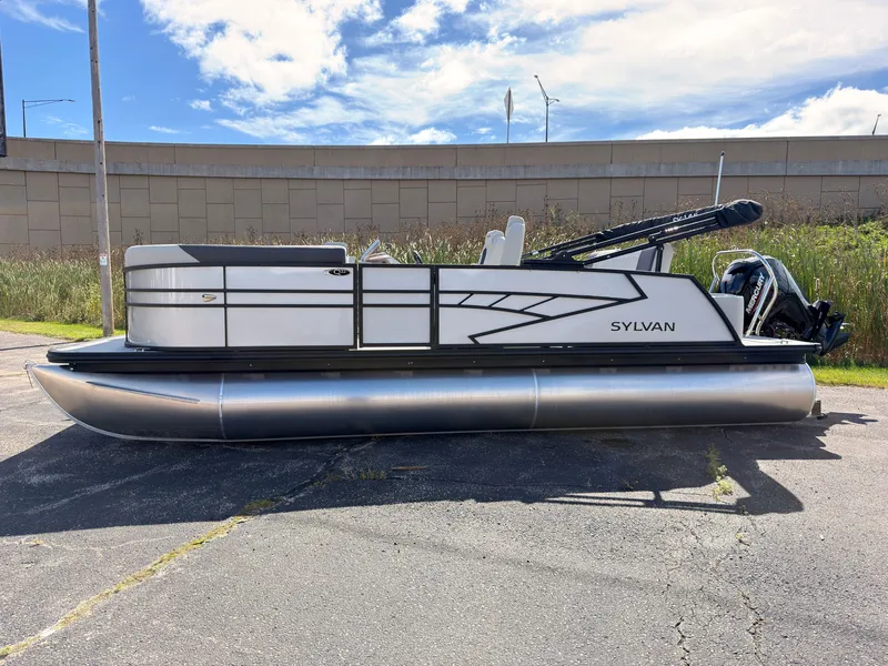 Slide: The Image of A 2027 Sylvan Q-22 ULZ pontoon boat is parked on a lot. It features a modern design. - 3