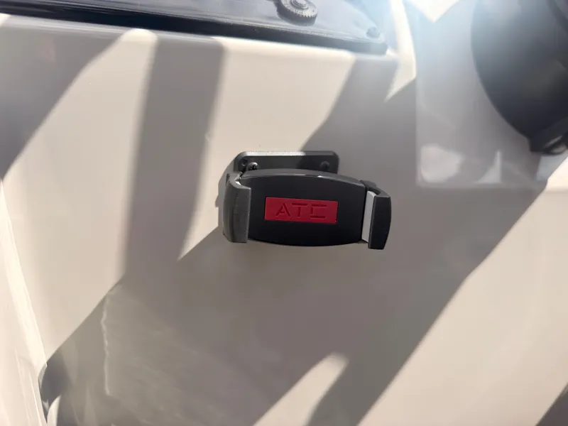 Slide: The Image of Close-up of a boat detail with a black and red handle on the white surface. - 35
