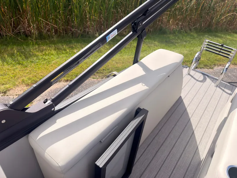 Slide: The Image of The image shows the deck of a 2027 Sylvan Q-22 ULZ boat with beige upholstery. - 44