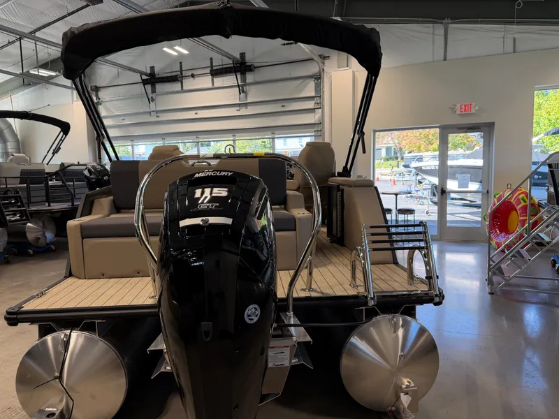 Slide: The Image of A 2027 Sylvan Q-22 ULZ pontoon boat is in a showroom. It features a Mercury 115 GT engine. - 3