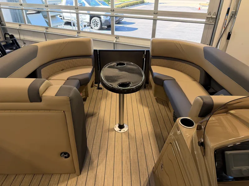 Slide: The Image of Interior of a 2027 Sylvan Q-22 ULZ with beige and gray seating and a round table. - 5