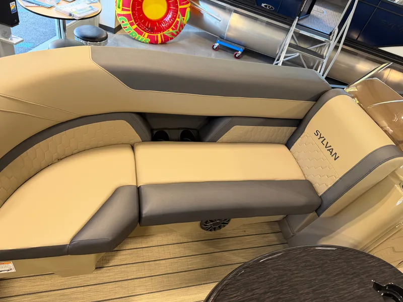 Slide: The Image of The image shows a beige and gray seating area in a Sylvan Q-22 ULZ boat. - 9