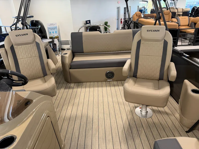 Slide: The Image of The image shows the interior of a 2027 Sylvan Q-22 ULZ with beige seating and striped flooring. - 23