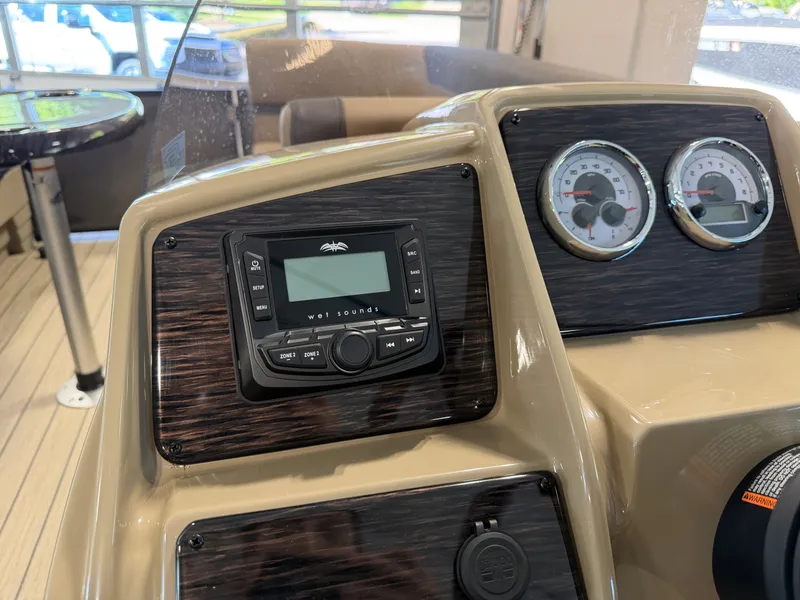 Slide: The Image of The image shows the dashboard of a 2027 Sylvan Q-22 ULZ with a sound system and gauges. - 19