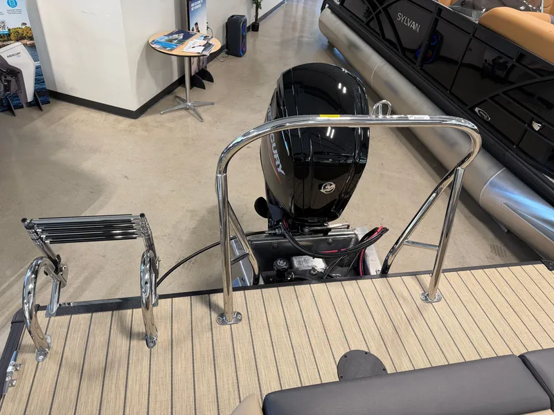 Slide: The Image of The image shows the rear of a Sylvan Q-22 ULZ pontoon boat with an outboard motor and swim ladder. - 28