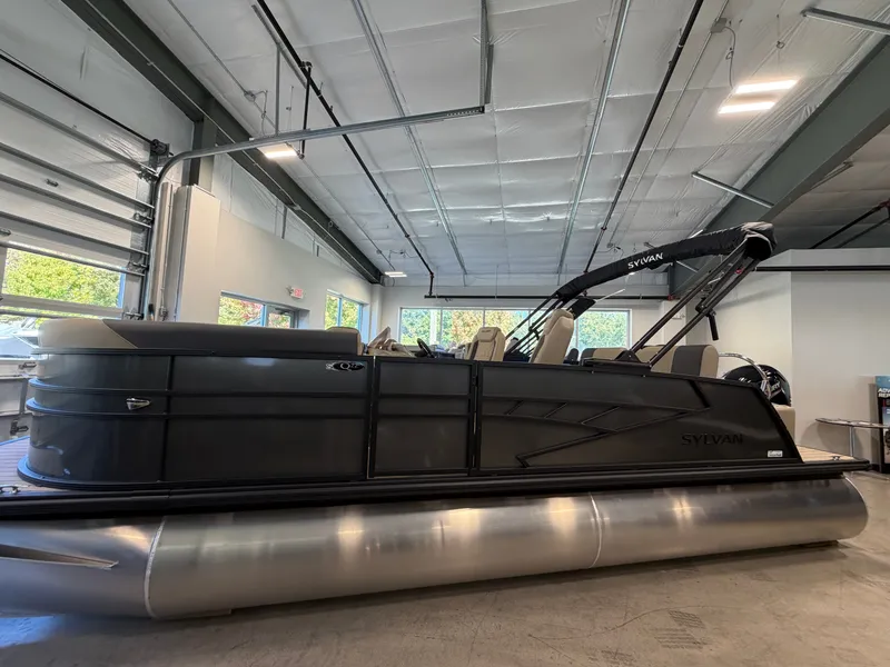 The Image of A 2027 Sylvan Q-22 ULZ pontoon boat is displayed in a modern showroom. - 0