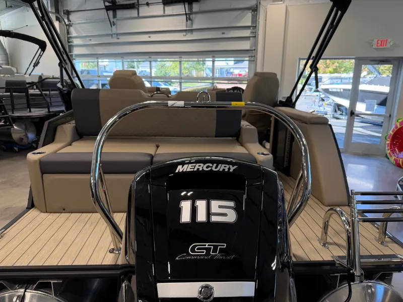 Slide: The Image of The image shows the rear of a 2027 Sylvan Q-22 ULZ boat with a Mercury 115 engine. - 29