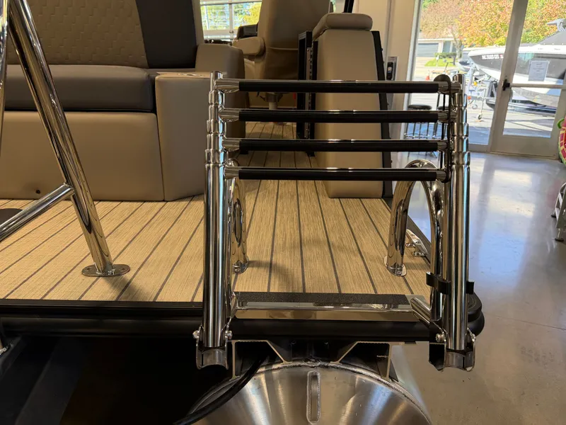 Slide: The Image of A 2027 Sylvan Q-22 ULZ with a foldable swim ladder on a wooden deck. - 30