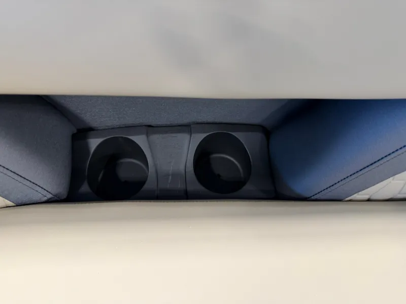 Slide: The Image of Close-up of two cup holders in a boat, surrounded by cushioned seating. - 10