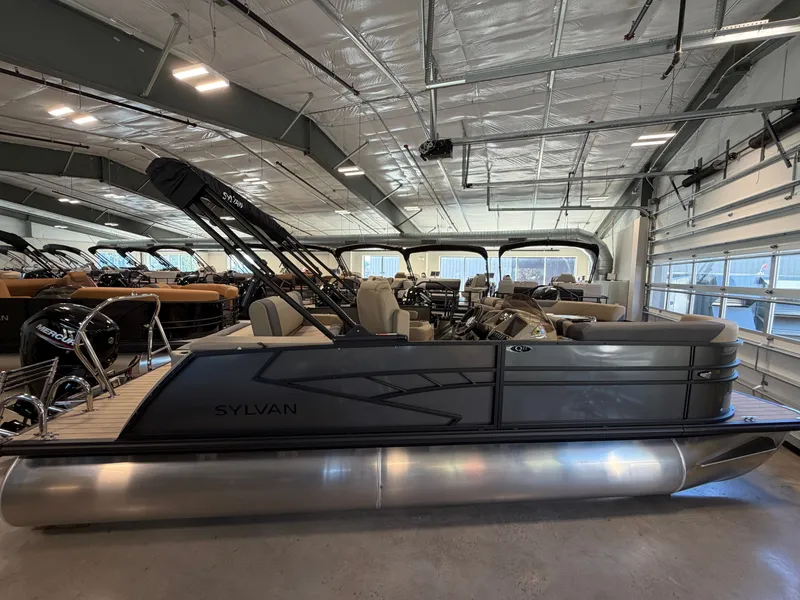 Slide: The Image of A 2027 Sylvan Q-22 ULZ pontoon boat is in a showroom. It features a sleek design. - 2