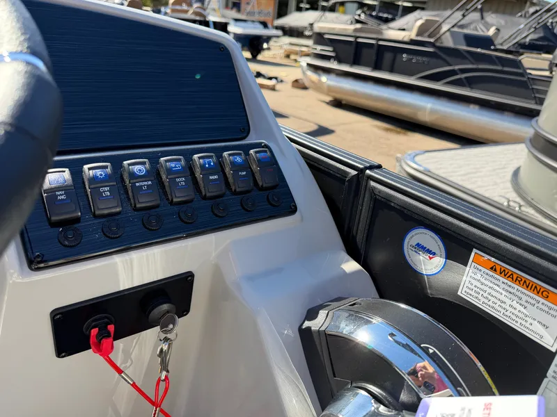 Slide: The Image of Close-up of a 2027 Sylvan Q-22 LZ helm with switches and throttle lever. - 18