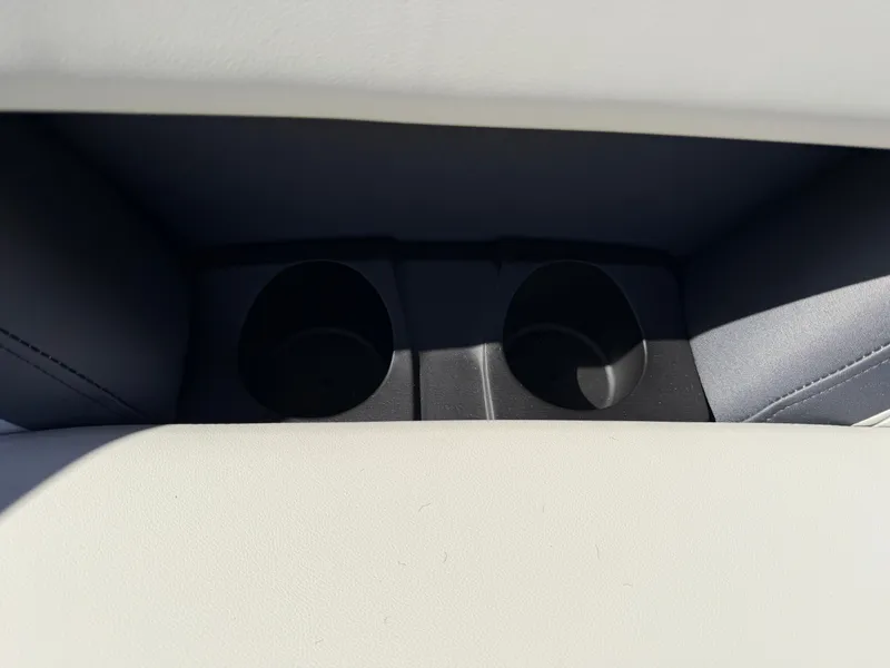 Slide: The Image of Two black cup holders are integrated into the white upholstery of a boat seat. - 23