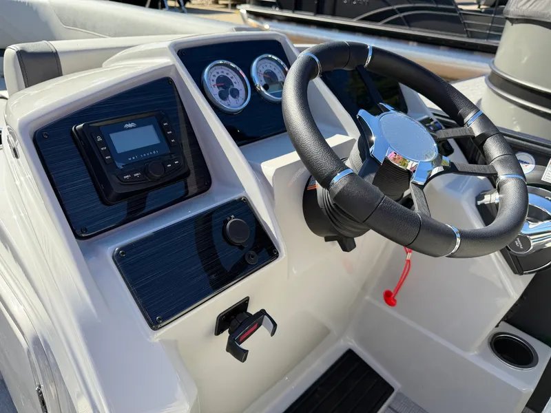 Slide: The Image of The image shows the helm of a 2027 Sylvan Q-22 LZ with steering wheel and instruments. - 17